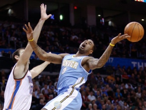 Denver Nuggets forward Gary Forbes, right, is fouled on the way to the basket by Oklahoma City Thunder center Nenad Krstic, left, in the first half of a NBA basketball game in Oklahoma City, Saturday, Dec. 25, 2010. (AP Photo/Alonzo Adams)