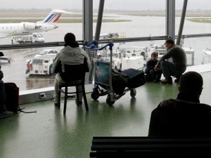 Passengers wait for their flights after all outgoing flights were canceled by an ongoing strike at Lyon-Saint Exupery airport in France on Saturday, Dec. 17, 2011. (AP Photo/Laurent Cipriani)