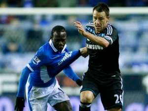 Chelsea's John Terry, right, vies for the ball against Wigan's Victor Moses during their English Premier League soccer match at the DW Stadium, Wigan, England, Saturday Dec. 17, 2011. (AP Photo/Tim Hales)