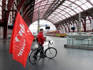 A union member wheels his flag-draped bike through an empty railway station in Antwerp, Belgium on Thursday, Dec. 22, 2011. A 24-hour pre-Christmas public sector strike to protest pension reform has hit rail and bus traffic across Belgium, but major airports were operating close to normal. The reforms are part of a slate of austerity measures approved by Prime Minister Elio Di Rupo's coalition to get Belgium out of the economic crisis. (AP Photo/Virginia Mayo)
