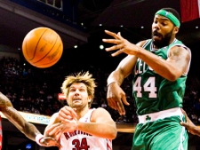 Boston Celtics player Chris Wilcox, right, battles with Toronto Raptors player Aaron Gray during NBA pre-season action in Toronto on Sunday, Dec. 18, 2011. THE CANADIAN PRESS/Chris Young