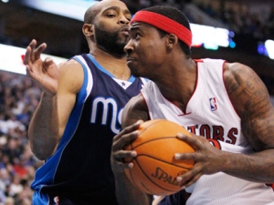 Toronto Raptors forward Ed Davis, right, drives against Dallas Mavericks forward Vince Carter, left, during the first half of an NBA basketball game in Dallas on Friday, Dec. 30, 2011. (AP Photo/Mike Fuentes)