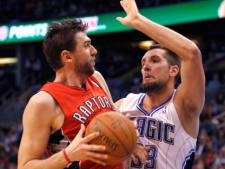 Toronto Raptors centre Andrea Bargnani, left, looks for room around Orlando Magic forward Ryan Anderson during an NBA game Sunday, Jan. 1, 2012, in Orlando, Fla. Orlando won 102-96. (AP Photo/Reinhold Matay)