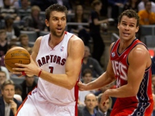 Toronto Raptors forward Andrea Bargnani, left, drives around New Jersey Nets forward Kris Humphries during first half NBA action in Toronto on Friday, Jan. 6, 2012. (AP Photo/The Canadian Press, Frank Gunn)