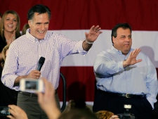 Republican presidential candidate Mitt Romney, left, waves with New Jersey Gov. Chris Christie during a campaign rally in Exeter, N.H. on Sunday, Jan. 8, 2012. (AP Photo/Elise Amendola)