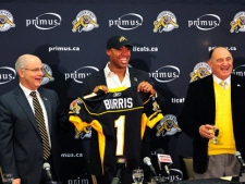 Hamilton Tiger-Cats vice-president of football operations Bob O'Billovich (right) introduces new head coach George Cortez (left) and quarterback Henry Burris (centre) at a news conference in Hamilton, Tuesday, Jan. 10, 2012. (THE CANADIAN PRESS/Simon Wilson)