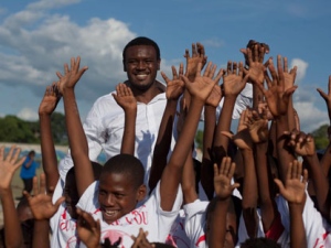 NBA Sacramento Kings� basketball player Samuel Dalembert, top, from Haiti, poses for pictures with children at the Athletique Club sport center in Port-au-prince, Haiti, Friday June 10, 2011. Dalembert is on a week visit to offer a basketball clinic for children. (AP Photo/Ramon Espinosa)