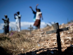 Relatives of those who died in the 2010 earthquake attend a memorial service at the mass grave site in Titanyen, on the outskirts of Port-au-Prince, Haiti, Thursday Jan. 12, 2012. Haitians are marking the second anniversary of the devastating 2010 earthquake with church services throughout the country on what is a national holiday of remembrance. The government has said the disaster killed 316,000 people and displaced 1.5 million. More than 500,000 are still in temporary settlement camps. (AP Photo/Ramon Espinosa)