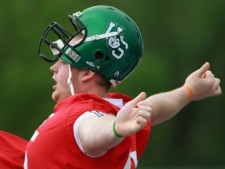 University of Saskatchewan tackle Ben Heenan yawns and stretches during an early-morning practice before the CIS East West Football Game at TD Waterhouse stadium in London, Ont., Friday, May 7, 2010. (THE CANADIAN PRESS/ Dave Chidley)