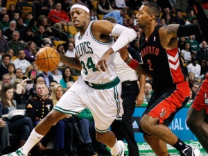 Boston Celtics forward Paul Pierce (34) drives against Toronto Raptors forward James Johnson (2) in the first quarter of an NBA basketball game in Boston, Wednesday, Jan. 18, 2012. (AP Photo/Elise Amendola)