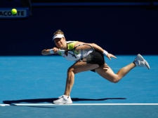 Belgium's Kim Clijsters reaches for a forehand return to China's Li Na during their fourth round match at the Australian Open tennis championship in Melbourne, Australia, Sunday, Jan. 22, 2012. (AP Photo/Aaron Favila)