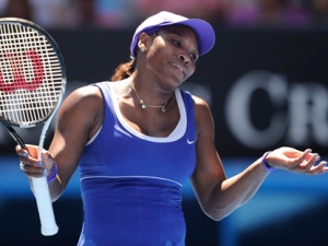 Serena Williams of the US reacts in frustration during her fourth round match against Russia's Ekaterina Makarova at the Australian Open tennis championship, in Melbourne, Australia, Monday, Jan. 23, 2012. (AP Photo/Andrew Brownbill)