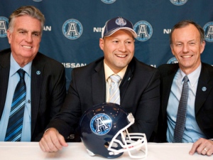 Toronto Argonauts head coach Scott Milanovich, centre, sits with general manager Jim Barker, left, and president Bob Nicholson following a press conference to announce Milanovich's hiring in Toronto on Thursday, Dec. 1, 2011. (THE CANADIAN PRESS/ Chris Young)