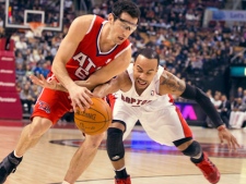 Atlanta Hawks guard Kirk Hinrich (left) and Toronto Raptors guard Jerryd Bayless (right) battle for the ball during first half NBA action in Toronto on Tuesday, Jan. 31, 2012. (THE CANADIAN PRESS/Frank Gunn)