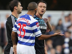 This is a Oct. 23, 2011 file photo of Chelsea captain John Terry. right, as he speaks with Queens Park Rangers' Anton Ferdinand, centre, during the English Premier League match at Loftus Road, London. England captain John Terry will not stand trial for racially abusing an opponent during a Premier League match until after the European Championship. Terry the Chelsea defender, who denies shouting offensive comments at Queens Park Rangers defender Anton Ferdinand during an October match, was not at Westminster Magistrates' Court on Wednesday to hear a trial date of July 9 set. (AP Photo/Nick Potts/PA)