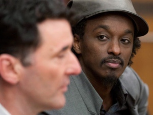 Musician K'naan listens to NDP MP Paul Dewar deliver opening remarks at the NDP party caucus meetings in Ottawa on Wednesday, March 9, 2011. (THE CANADIAN PRESS/Adrian Wyld)