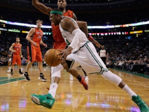 Boston Celtics forward Paul Pierce drives the baseline around Toronto Raptors forward James Johnson during the first half of their NBA basketball game at the Garden in Boston on Wednesday, Feb. 1, 2012. (AP Photo/Stephan Savoia)