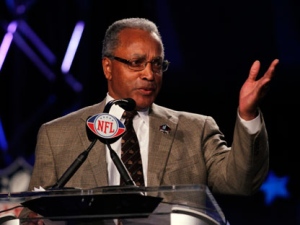 Stephen A. Perry, president of the Pro Football Hall of Fame, announces the 2012 class for the Pro Football Hall of Fame during an NFL football news conference, Saturday, Feb. 4, 2012, in Indianapolis. The class includes Pittsburgh Steelers cornerback Jack Butler, Pittsburgh Steelers center Dermontti Dawson, Minnesota Vikings defensive end Chris Doleman, Seattle Seahawks defensive tackle Cortez Kennedy, New England Patriots and New York Jets running back Curtis Martin, and New Orleans Saints and Kansas City Chiefs tackle Willie Roaf. (AP Photo/Michael Conroy)
