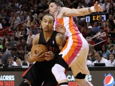 Toronto Raptors' Jerryd Bayless, left, drives around Miami Heat's Mike Miller (13) in the second half of an NBA basketball game in Miami, Sunday, Feb. 5, 2012. The Heat won 95-89. (AP Photo/Alan Diaz)