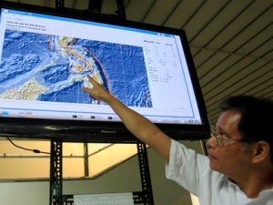 Bartolome Bautista, deputy director of the Philippine Institute of Volcanology and Seismology (PHIVOLCS), points to the epicentre of a magnitude 6.8 earthquake which hit central Philippines on Monday Feb. 6, 2012. (AP Photo/Bullit Marquez)