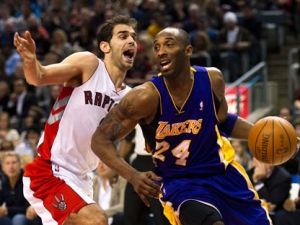 Toronto Raptors guard Jose Calderon, left, battles for the ball with Los Angeles Lakers guard Kobe Bryant (24) during first half NBA basketball action in Toronto on Sunday, Feb. 12, 2012. THE CANADIAN PRESS/Nathan Denette