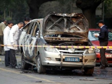 Indian security and forensic officials examine a car belonging to the Israel Embassy after an explosion tore through that in New Delhi, India on Monday, Feb. 13, 2012. The driver and a diplomat's wife were injured, according to Indian officials. (AP Photo/Mustafa Quraishi)