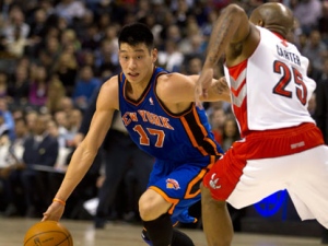 New York Knicks guard Jeremy Lin (17) drives against Toronto Raptors guard Anthony Carter during first half NBA action in Toronto on Tuesday, Feb. 14, 2012. (THE CANADIAN PRESS/Frank Gunn)