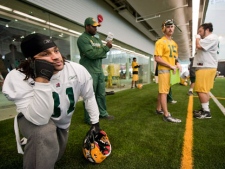 The Edmonton Eskimos Jason Barnes, foreground, waits on the sideline during practice in Edmonton on Friday, Nov. 18, 2011 prior to Sunday's CFL Western Final against the B.C. Lions in Vancouver. (THE CANADIAN PRESS/John Ulan)