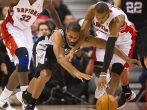 Toronto Raptors guard Leandro Barbosa, right, battles for the ball against San Antonio Spurs guard Gary Neal, left, during first half NBA basketball action in Toronto on Wednesday, Feb. 15, 2012. (THE CANADIAN PRESS/Nathan Denette)