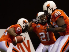 B.C. Lions' Dante Marsh, from left, Ryan Phillips and Khalif Mitchell celebrate Marsh's interception against the Montreal Alouettes during the second half of a CFL football game in Vancouver, B.C., on Saturday November 5, 2011. THE CANADIAN PRESS/Darryl Dyck