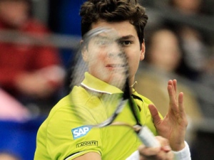 Milos Raonic, of Canada, returns a shot to Benjamin Becker in their semifinal match at the Regions Morgan Keegan Championships tennis tournament on Saturday, Feb. 25, 2012, in Memphis, Tenn. (AP Photo/Mark Humphrey)