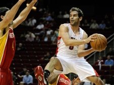 Toronto Raptors' Jose Calderon (8) looks to pass around Houston Rockets' Luis Scola (4) in the first half of an NBA basketball game in Houston on Tuesday, Feb. 28, 2012. (AP Photo/Pat Sullivan)