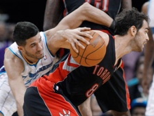 Toronto Raptors guard Jose Calderon (8) breaks to the basket as New Orleans Hornets guard Greivis Vasquez (21) gets caught on a screen in the first half of an NBA basketball game in New Orleans on Wednesday, Feb. 29, 2012. (AP Photo/Bill Haber)