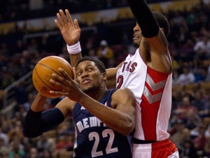 Memphis Grizzlies' Rudy Gay jumps to the net as Toronto Raptors' James Johnson defends during first half NBA play in Toronto on Friday, March 2, 2012. (THE CANADIAN PRESS/Pawel Dwulit)