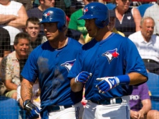 Toronto Blue Jays J.P. Arencibia (right) is congratulated by teammate Brett Lawrie after hitting a two run homer off New York Yankees starting pitcher Ivan Nova during second inning Spring Training action in Dunedin, Fla. on Thursday March 8, 2012. THE CANADIAN PRESS/Frank Gunn