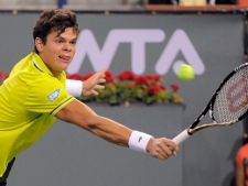 Milos Raonic returns a shot to Roger Federer at the BNP Paribas Open tennis tournament, Tuesday, March 13, 2012, in Indian Wells, Calif. (AP Photo/Mark J. Terrill) 