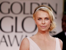 Actress Charlize Theron arrives at the 69th Annual Golden Globe Awards on Sunday, Jan. 15, 2012, in Los Angeles. (AP Photo/Matt Sayles)