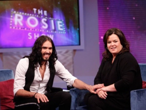 In this image released by Harpo, Inc., British actor Russell Brand, left, is shown with host Rosie O'Donnell during the debut of "The Rosie Show," on Monday, Oct. 10, 2011 in Chicago. (AP Photo/Harpo, Inc., George Burns)