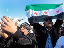 Syrian citizens who live in Lebanon wave the Syrian revolutionary flag and shout slogans against Syrian President Bashar Assad, as they attend an anti-Syrian regime protest held by Lebanese intellectuals, at the Martyrs square in downtown Beirut, Lebanon, on Saturday March 17, 2012. (AP Photo/Hussein Malla)