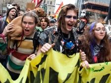 Occupy Wall Street demonstrators march near Zuccotti Park on Saturday, March 17, 2012, in New York. With the city's attention focused on the huge St. Patrick's Day Parade many blocks uptown, the Occupy rally at Zuccotti Park on Saturday drew a far smaller crowd than the demonstrations seen in the city when the movement was at its peak in the fall. A couple hundred people attended. (AP Photo/John Minchillo)