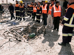 This photo released by the Syrian official news agency SANA shows Syrian rescue teams investigating the scene after an explosion in Aleppo, Syria, Sunday, March 18, 2012. An explosion ripped through a residential neighborhood in the northern Syrian city of Aleppo on Sunday and the state news agency said it was a "terrorist bombing." The report by SANA gave no information on casualties in what appeared to be the second attack in two days on cities where President Bashar Assad's regime enjoys strong support. (AP Photo/SANA)