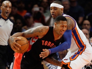 Toronto Raptors' James Johnson (2) is defended by New York Knicks' Carmelo Anthony (7) during the first half of an NBA basketball game on Tuesday, March 20, 2012, in New York. (AP Photo/Frank Franklin II)