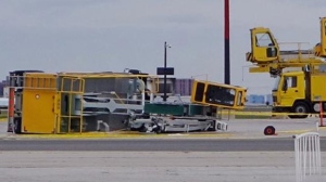 Deicing vehicle flips over at Pearson