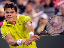 Milos Raonic, of Canada, returns a shot to Roger Federer, of Switzerland, at the BNP Paribas Open tennis tournament on Tuesday, March 13, 2012, in Indian Wells, Calif. (AP Photo/Mark J. Terrill)