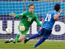 Canada goalkeeper Michal Misiewicz (18) blocks a shot by El Salvador's Andres Flores (20) in the first half of a CONCACAF Olympic qualifying soccer match on Thursday, March 22, 2012, in Nashville, Tenn. (AP Photo/Mark Humphrey)