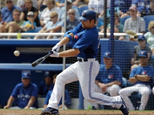 Toronto Blue Jays' Adam Lind hits a third-inning, three-run, home run off Atlanta Braves starting pitcher Randall Delgado during their spring training baseball game in Dunedin, Fla., Saturday, March 24, 2012. Yunel Escobar and Omar Vizquel scored on the home run. (AP Photo/Kathy Willens)