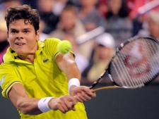 Milos Raonic, of Canada, returns a shot to Roger Federer, of Switzerland, at the BNP Paribas Open tennis tournament, Tuesday, March 13, 2012, in Indian Wells, Calif. (AP Photo/Mark J. Terrill) 