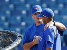 Toronto Blue Jays manager John Farrell talks to Yunel Escobar during batting practice before a spring training baseball game against the New York Yankees at Steinbrenner Field in Tampa, Fla. on Tuesday, March 27, 2012. (AP Photo/Kathy Willens)