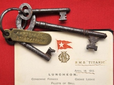 This Wednesday March 28, 2012 shows a menu given to first class passengers on the day of the sinking of the Titanic and a set of keys used by Titanic crewman Samuel Hemming to unlock the door where the lifeboat lanterns were held after he was ordered by the ship's Captain to ensure all 15 lifeboats had lit oil lamps, as part of an auction of Titanic memorabilia at Henry Aldridge and Son in Devizes, England to commemorate the centenary of the ships completion. The menu, kept by a prominent San Francisco banker, bears the date April 14, the day in 1912 that the reputedly unsinkable cruiser hit an iceberg and fell to the bottom of the Atlantic. (AP Photo/Tim Ireland/PA Wire) 