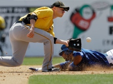 Pittsburgh Pirates shortstop Clint Barmes, left, catches Toronto Blue Jays designated hitter Edwin Encarnacion, right, stealing in the fourth-inning of the Pirates' 2-1 victory in a spring training baseball game in Dunedin, Fla., Sunday, April 1, 2012. (AP Photo/Kathy Willens)